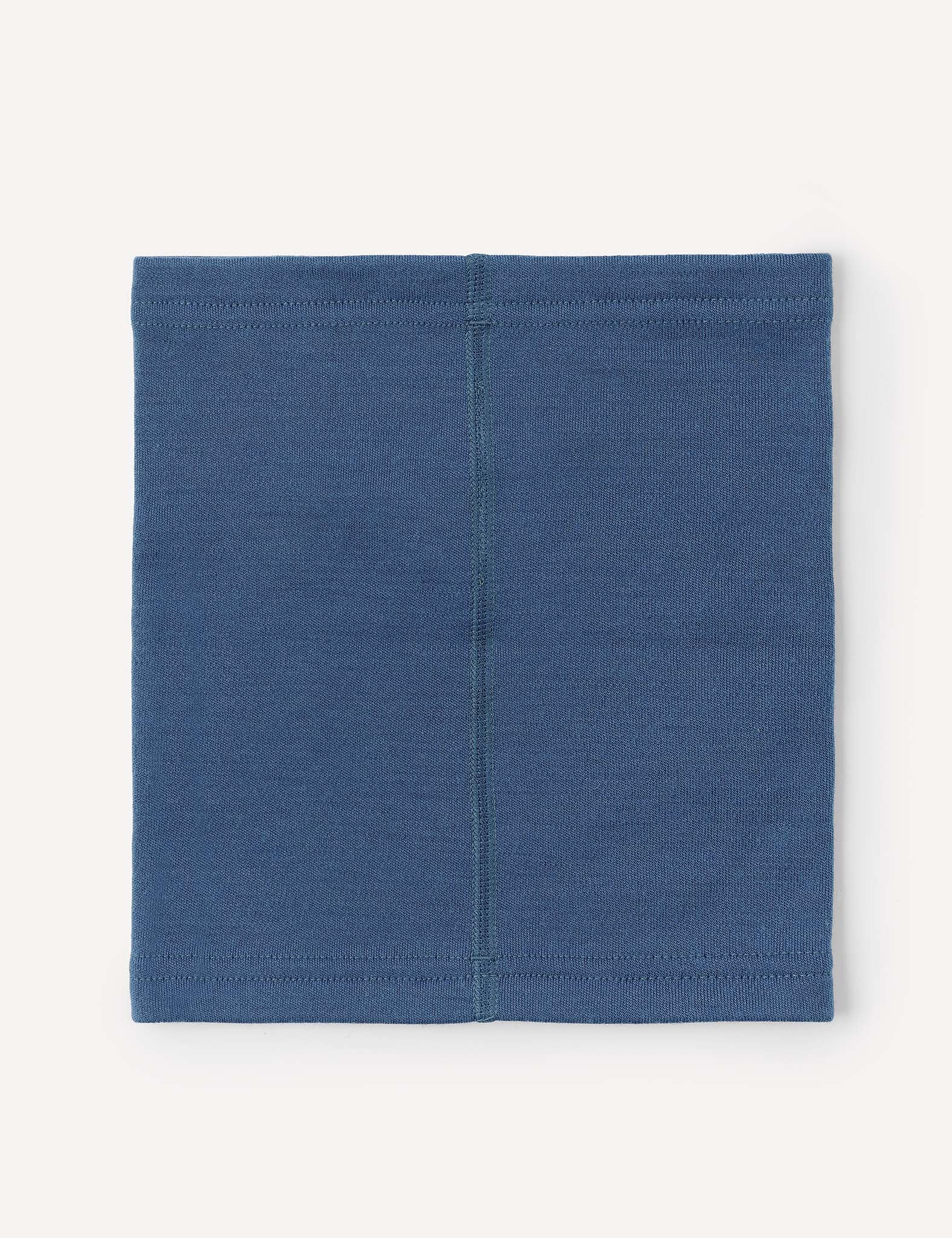 The Neckwarmer – Merino Kids AirWool in blue is laid flat, displaying a visible vertical center seam. The stitching around the edges and its simple rectangular design are clearly shown.
