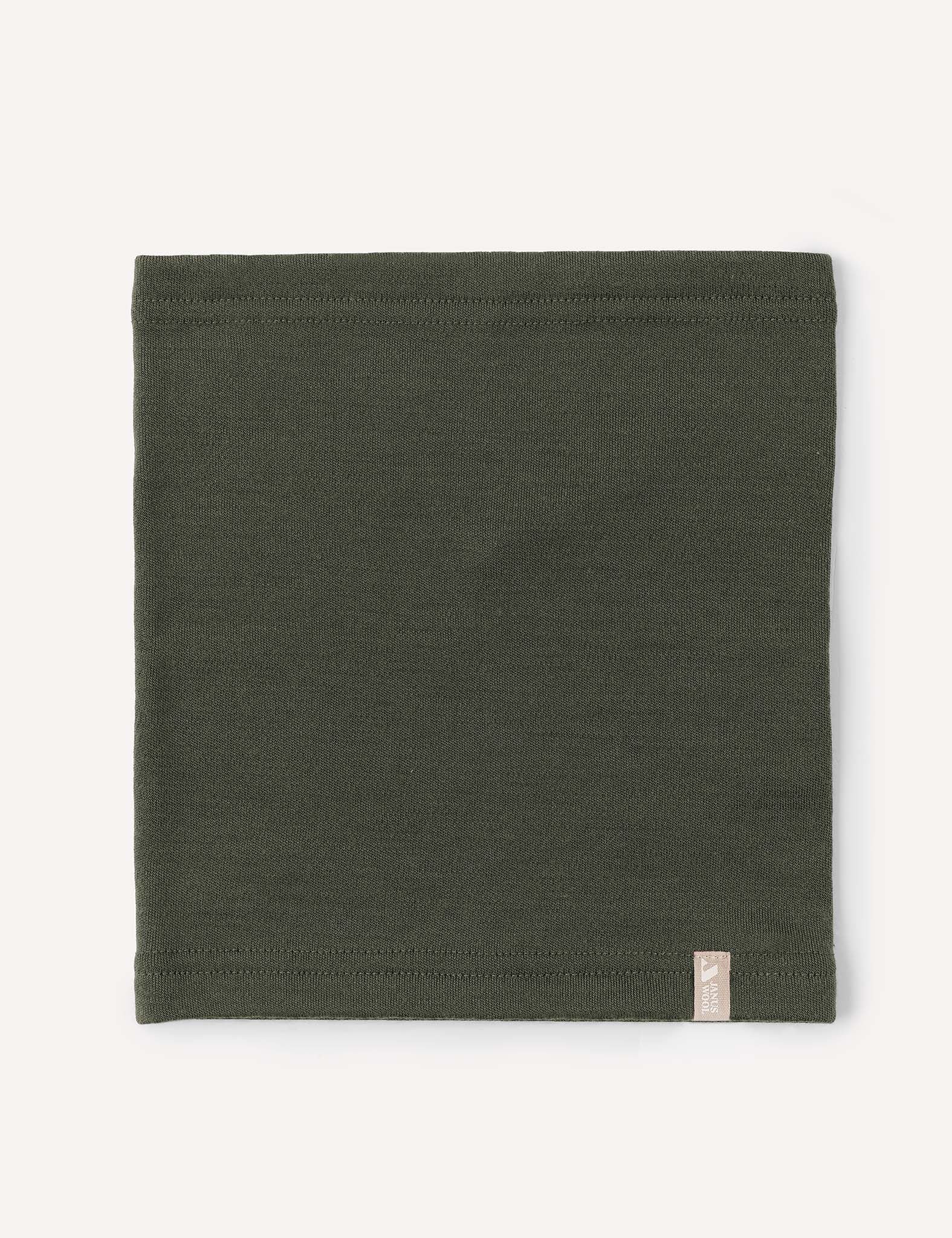 A neatly folded, rectangular olive green Neckwarmer – Merino Kids AirWool with a small beige tag on the lower right edge, displayed on a light background.