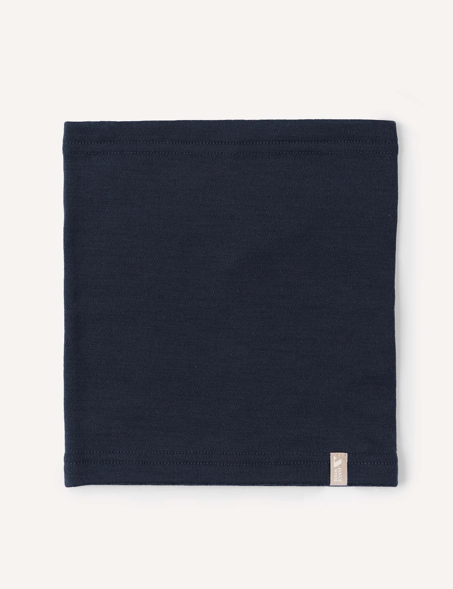 A folded, dark navy blue Neckwarmer – Merino Kids AirWool with a small rectangular tag on the lower edge, displayed on a plain light background.