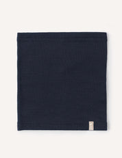 A folded, dark navy blue Neckwarmer – Merino Kids AirWool with a small rectangular tag on the lower edge, displayed on a plain light background.