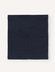 The Merino Kids AirWool Neckwarmer is shown in navy blue, featuring simple stitching and laid flat on a light background. This rectangular cloth tube has a plain design with visible seams running vertically and along the top and bottom edges.