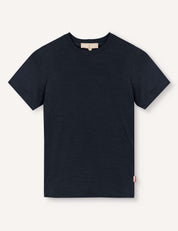 The T-Shirt – Merino Kids Light in Navy is displayed flat against a light background, offering all-day comfort and natural temperature regulation.