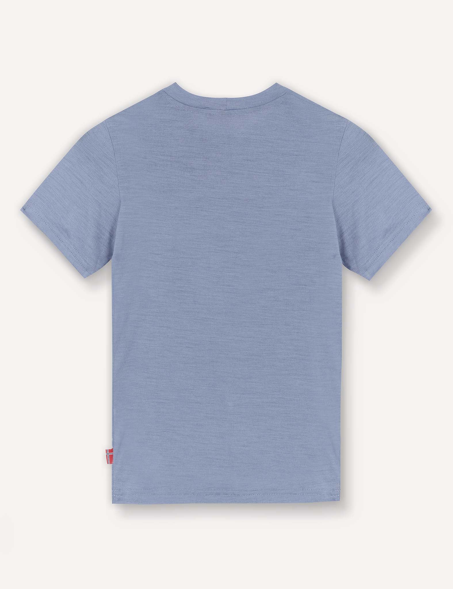 The T-Shirt – Merino Kids Light is shown from the back against a white background, featuring a plain light blue design with short sleeves made from merino wool for natural temperature regulation and all-day comfort.